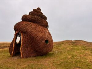 A snail sculpture that looks like a poo